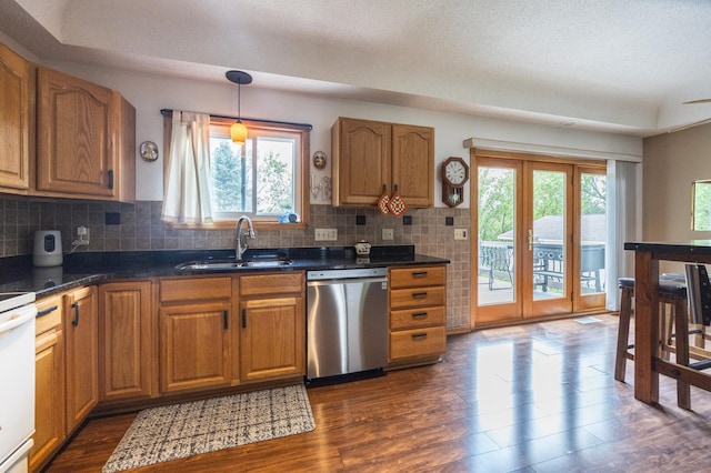 kitchen with dishwasher, a sink, dark wood-type flooring, and backsplash