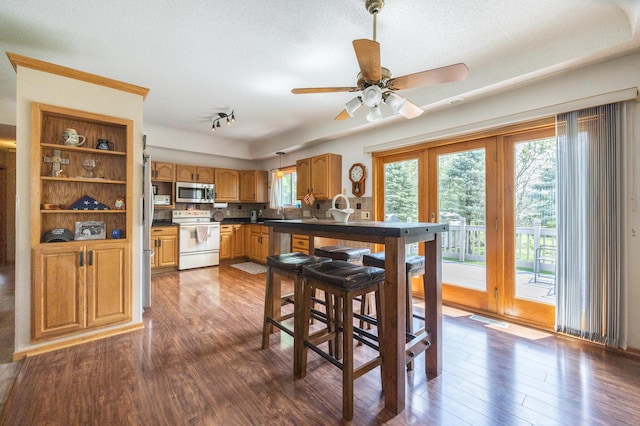 dining space with dark wood-style floors, a ceiling fan, and a textured ceiling