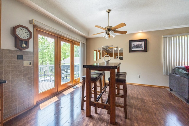dining area with dark wood finished floors, ceiling fan, and a textured ceiling