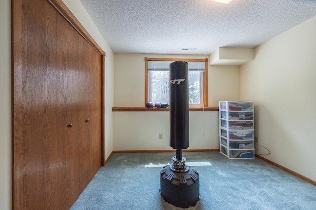 unfurnished bedroom featuring carpet floors, a textured ceiling, a closet, and baseboards