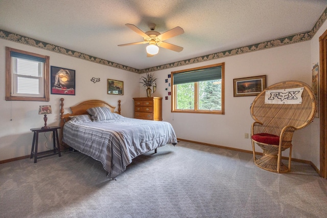 carpeted bedroom featuring baseboards, a ceiling fan, and a textured ceiling