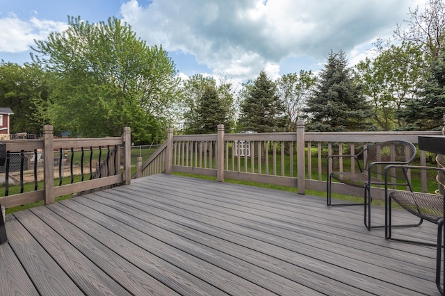 wooden terrace with view of wooded area