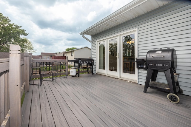 wooden terrace with a grill