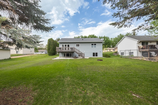 rear view of house featuring a wooden deck and stairway