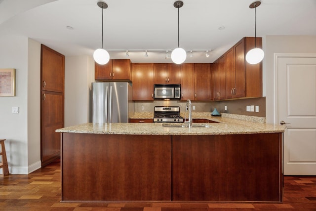 100 3rd Ave S Unit 1107, Minneapolis, MN 55401 - kitchen with stainless steel appliances, a sink, rail lighting, light stone countertops, and dark wood-type flooring