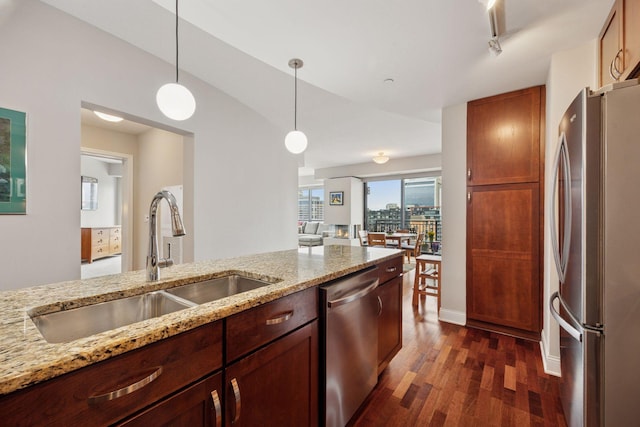 100 3rd Ave S Unit 1107, Minneapolis, MN 55401 - kitchen with appliances with stainless steel finishes, a sink, dark wood-style floors, hanging light fixtures, and light stone countertops