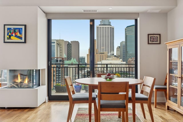 100 3rd Ave S Unit 1107, Minneapolis, MN 55401 - dining area with wood finished floors and a skyline view