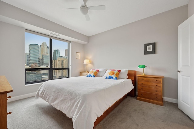 100 3rd Ave S Unit 1107, Minneapolis, MN 55401 - carpeted bedroom with baseboards, a view of skyline, and a ceiling fan