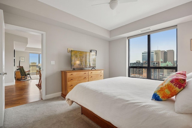 100 3rd Ave S Unit 1107, Minneapolis, MN 55401 - bedroom featuring multiple windows, light colored carpet, baseboards, and a ceiling fan