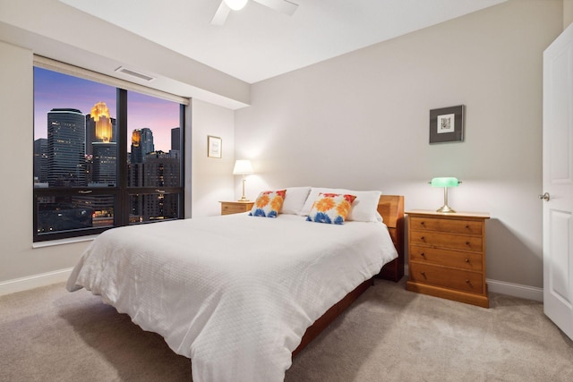 100 3rd Ave S Unit 1107, Minneapolis, MN 55401 - bedroom with carpet, baseboards, a ceiling fan, and a view of skyline