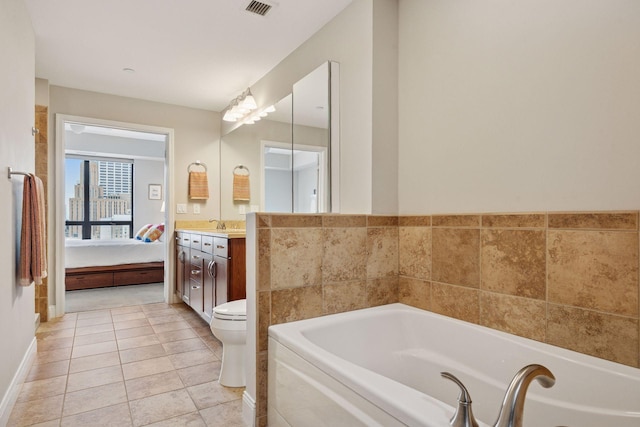 100 3rd Ave S Unit 1107, Minneapolis, MN 55401 - ensuite bathroom featuring a garden tub, vanity, toilet, and tile patterned floors