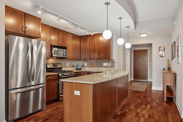 100 3rd Ave S Unit 1107, Minneapolis, MN 55401 - kitchen with appliances with stainless steel finishes, a sink, dark wood-type flooring, rail lighting, and light stone countertops