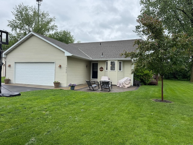 10428 Martha Lake Dr, Chisago City, MN 55013 - back of property with a yard, an attached garage, roof with shingles, asphalt driveway, and a patio area