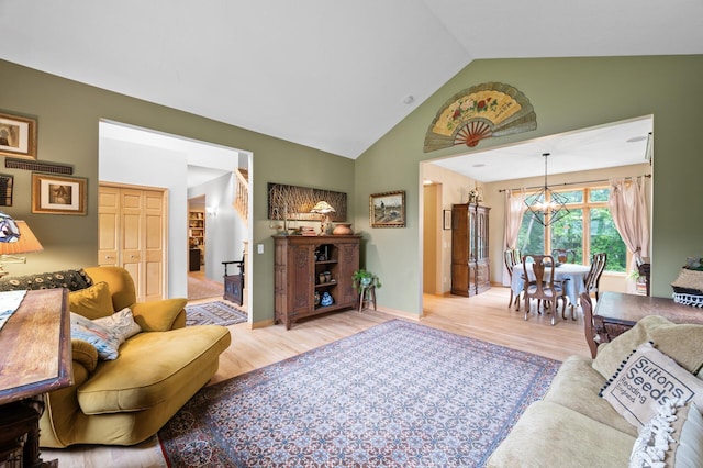 1665 3rd St SW, New Brighton, MN 55112 - living area with a chandelier, light wood-style flooring, high vaulted ceiling, and baseboards