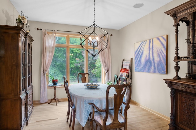 1665 3rd St SW, New Brighton, MN 55112 - dining space featuring a chandelier, light wood-type flooring, and baseboards