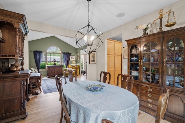 1665 3rd St SW, New Brighton, MN 55112 - dining room featuring light wood-style flooring, a chandelier, and lofted ceiling