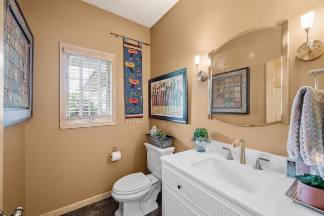 1665 3rd St SW, New Brighton, MN 55112 - bathroom with toilet, vanity, tile patterned flooring, and baseboards