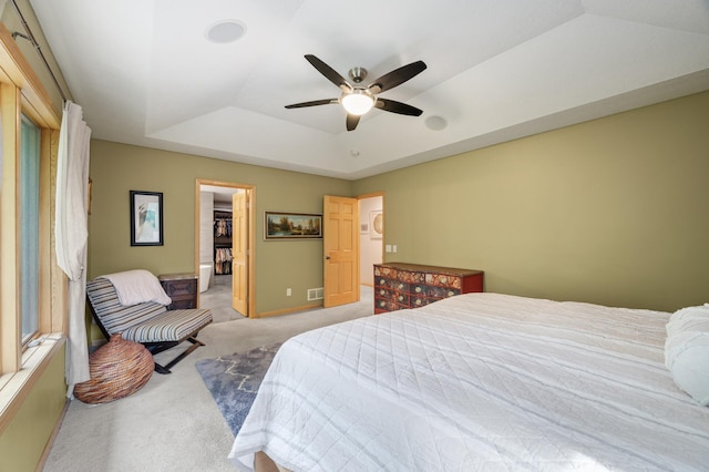 1665 3rd St SW, New Brighton, MN 55112 - carpeted bedroom featuring a tray ceiling, a walk in closet, baseboards, a ceiling fan, and a closet