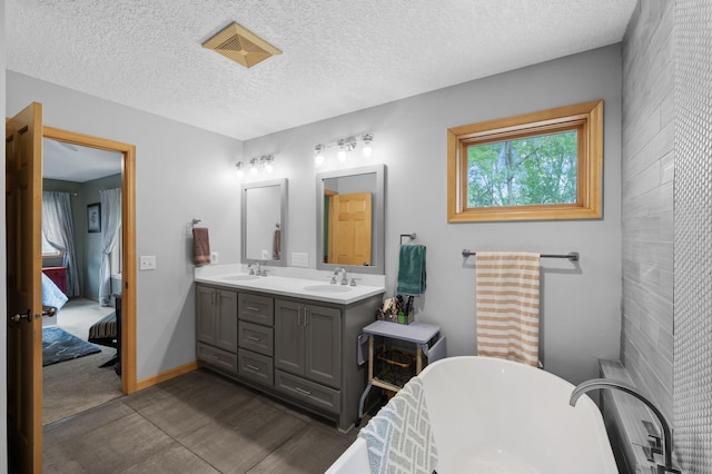 1665 3rd St SW, New Brighton, MN 55112 - ensuite bathroom featuring double vanity, a soaking tub, a textured ceiling, and baseboards