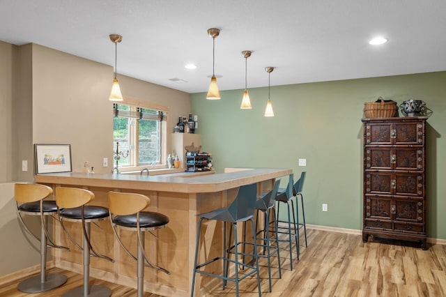 1665 3rd St SW, New Brighton, MN 55112 - indoor wet bar with light wood finished floors, baseboards, recessed lighting, and hanging light fixtures