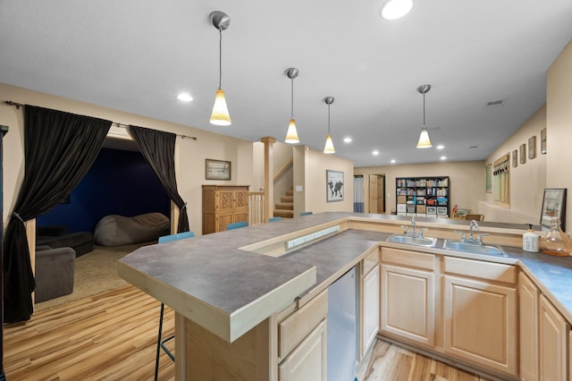 1665 3rd St SW, New Brighton, MN 55112 - kitchen with light wood-type flooring, open floor plan, light brown cabinetry, dishwasher, and recessed lighting