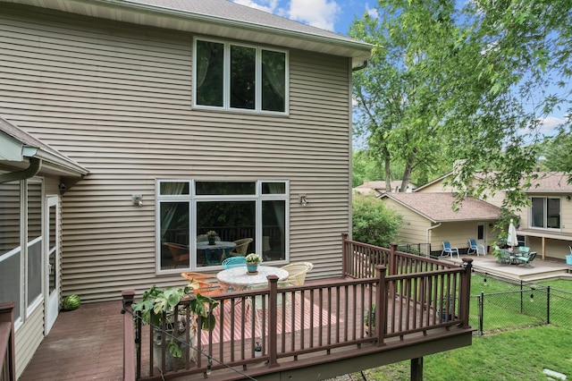 1665 3rd St SW, New Brighton, MN 55112 - rear view of property featuring a deck and outdoor dining space