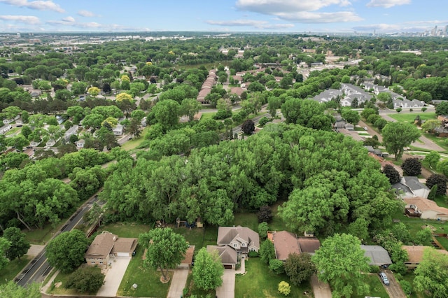 1665 3rd St SW, New Brighton, MN 55112 - aerial view of property's location with nearby suburban area and a tree filled landscape