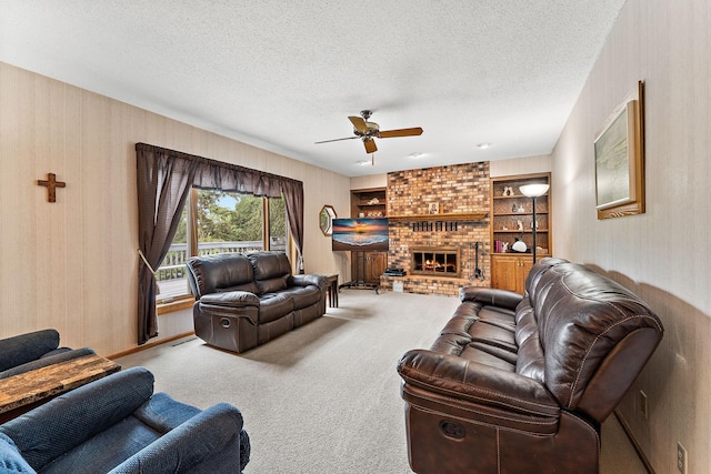 2501 112th St, Bloomington, MN 55431 - carpeted living area with a ceiling fan, a textured ceiling, a fireplace, and built in features