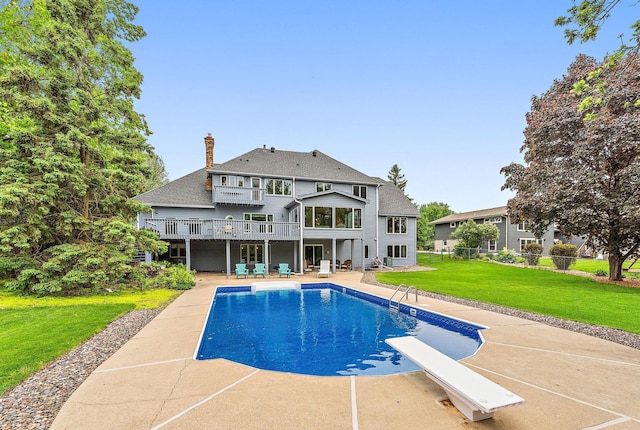 2501 112th St, Bloomington, MN 55431 - back of property featuring a patio, a chimney, a deck, roof with shingles, and an outdoor pool