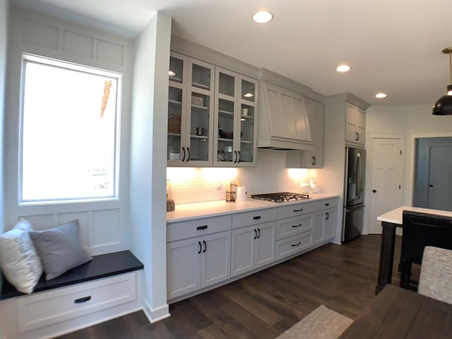 4605 130th Ln NE, Blaine, MN 55449 - kitchen featuring appliances with stainless steel finishes, dark wood-style floors, glass insert cabinets, custom range hood, and recessed lighting