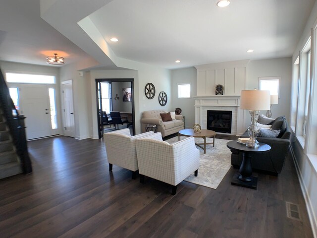 4605 130th Ln NE, Blaine, MN 55449 - living room featuring dark wood-style floors, a glass covered fireplace, recessed lighting, and stairway