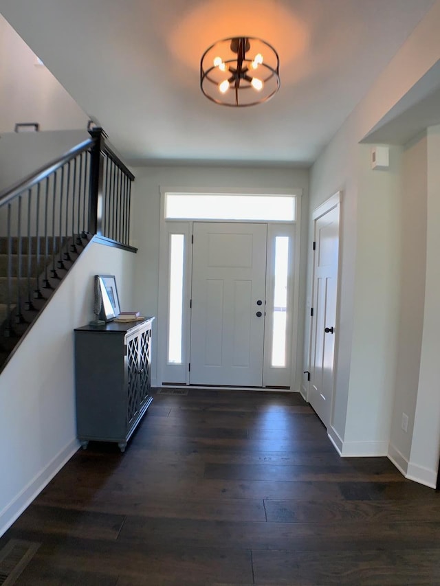 4605 130th Ln NE, Blaine, MN 55449 - foyer with dark wood-type flooring, baseboards, stairs, and a chandelier
