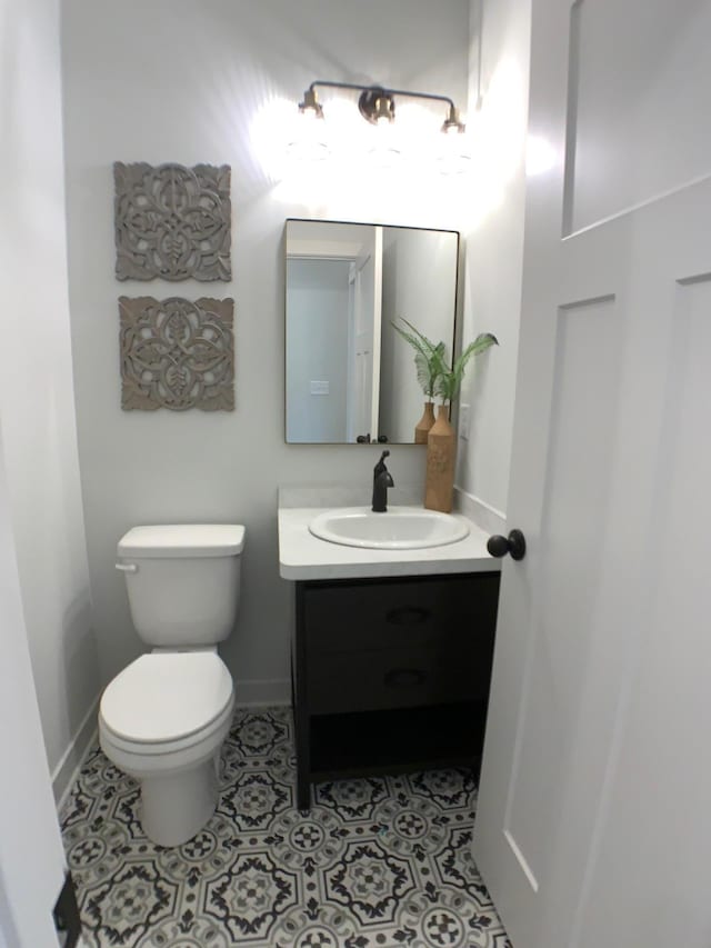 4605 130th Ln NE, Blaine, MN 55449 - bathroom featuring vanity, baseboards, toilet, and tile patterned flooring
