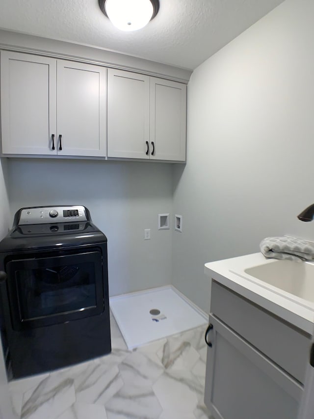4605 130th Ln NE, Blaine, MN 55449 - washroom featuring washer / clothes dryer, marble finish flooring, cabinet space, and a textured ceiling