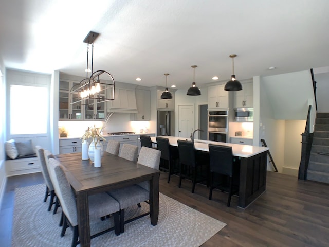 4605 130th Ln NE, Blaine, MN 55449 - dining room with stairway, recessed lighting, dark wood finished floors, and a chandelier