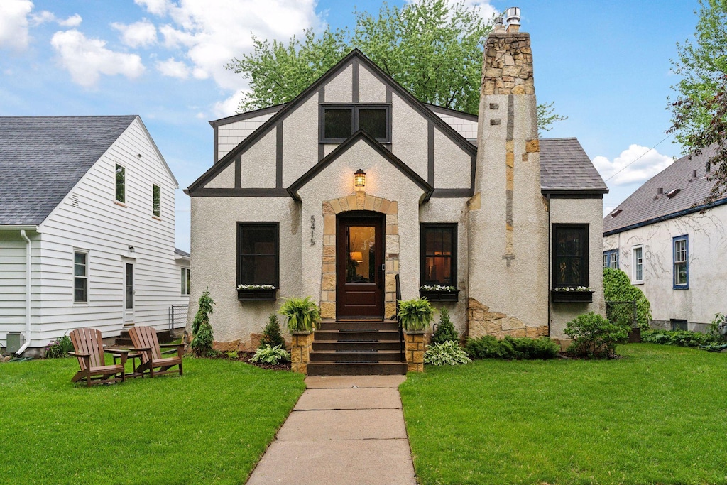 5415 Aldrich Ave S, Minneapolis, MN 55419 - tudor house with a front lawn, a chimney, stucco siding, and stone siding