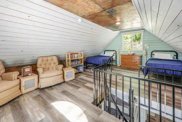 23873 Arcade Loop, Crow Wing Lake Twp, MN 56464 - bedroom with wood finished floors, lofted ceiling, and wood walls