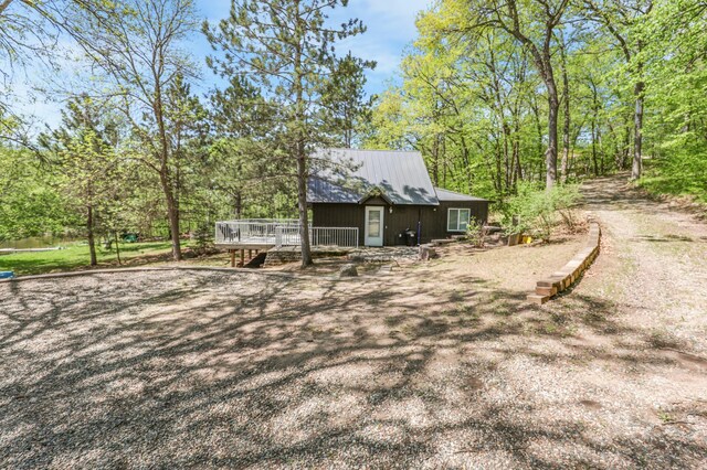 23873 Arcade Loop, Crow Wing Lake Twp, MN 56464 - back of property with a wooden deck and metal roof