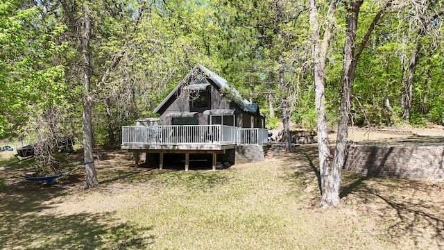 23873 Arcade Loop, Crow Wing Lake Twp, MN 56464 - rear view of house with a wooden deck, a wooded view, and a yard
