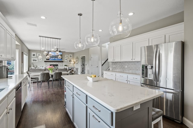 2940 Tiflawn Ct, Shakopee, MN 55379 - kitchen with stainless steel appliances, open floor plan, backsplash, white cabinetry, and recessed lighting