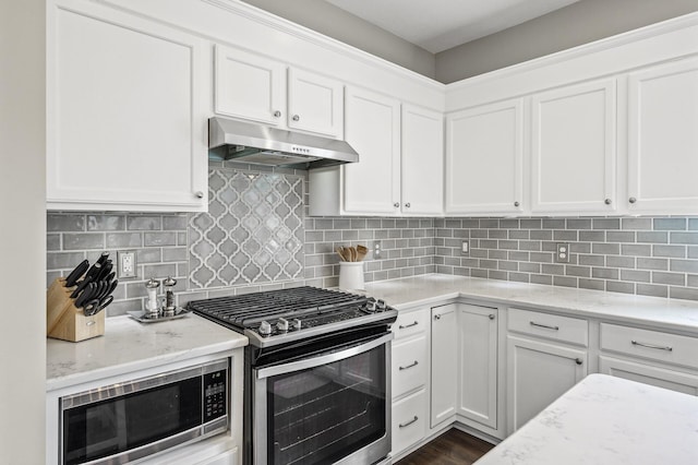 2940 Tiflawn Ct, Shakopee, MN 55379 - kitchen featuring appliances with stainless steel finishes, under cabinet range hood, light stone countertops, and white cabinets
