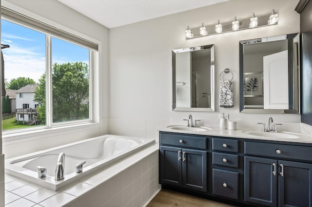 2940 Tiflawn Ct, Shakopee, MN 55379 - full bathroom with a bath, double vanity, and wood finished floors