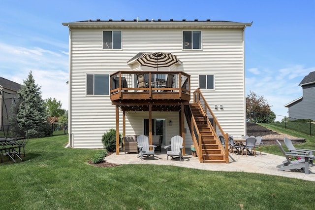 2940 Tiflawn Ct, Shakopee, MN 55379 - back of property with a trampoline, a patio, a deck, and stairway