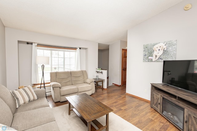 living area featuring wood finished floors and baseboards