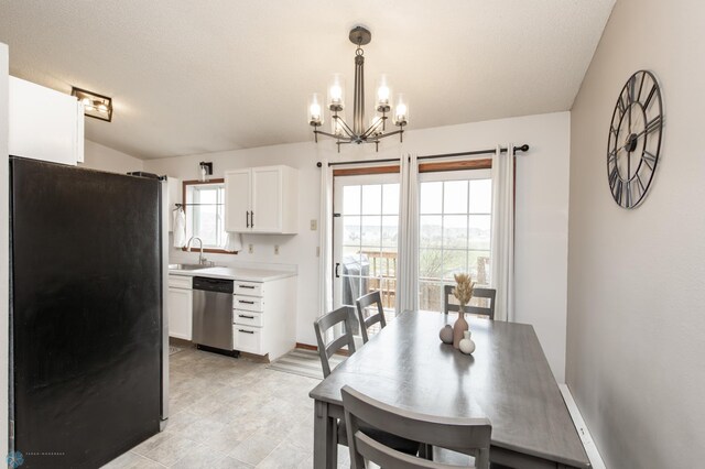 dining area featuring a chandelier and baseboards