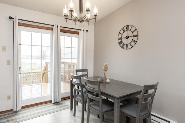 dining space featuring a chandelier and a baseboard radiator