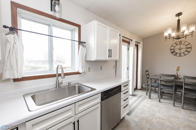 kitchen featuring stainless steel dishwasher, a sink, a chandelier, white cabinets, and light countertops