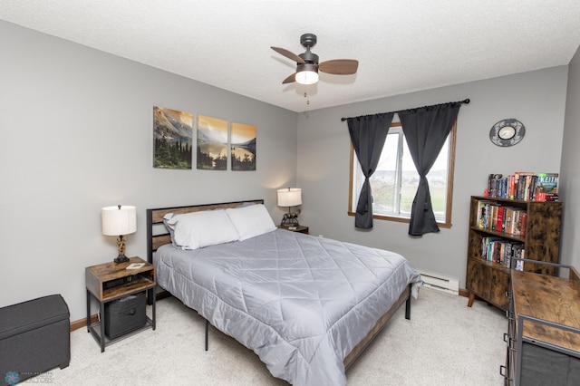 carpeted bedroom featuring baseboard heating, baseboards, and ceiling fan