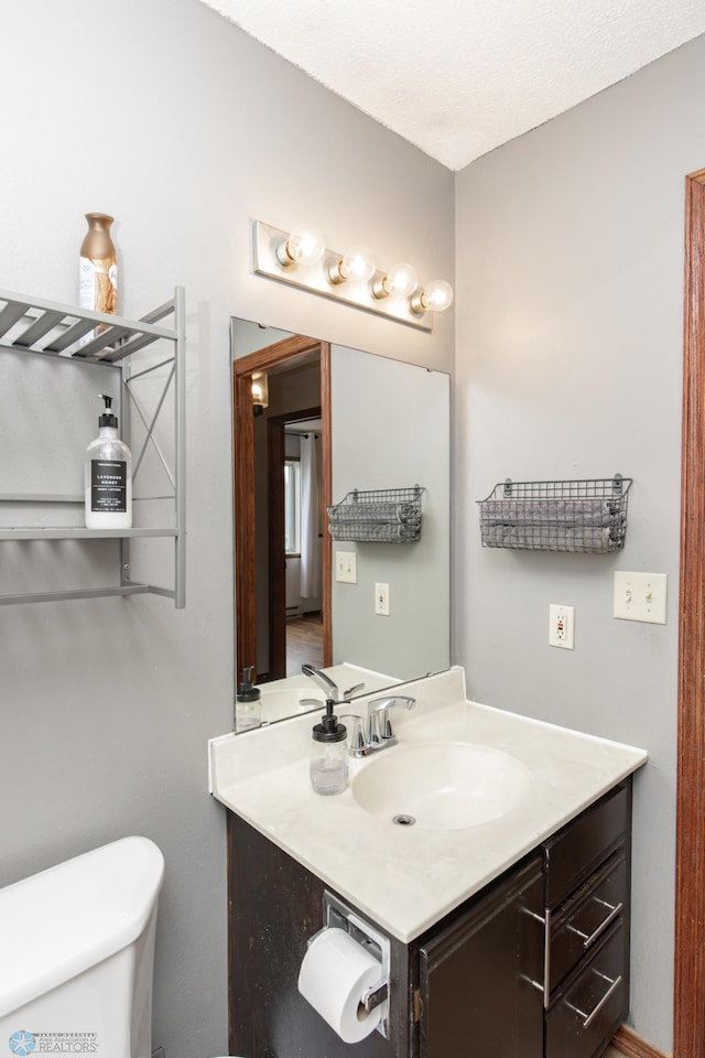 half bath with vanity and toilet