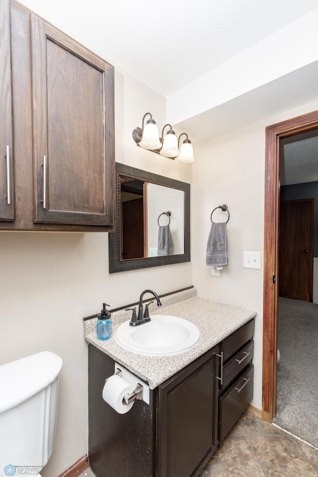 bathroom with toilet and vanity
